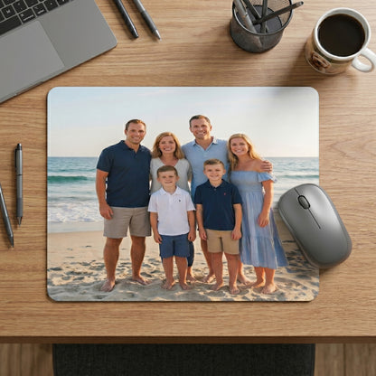 Personalized mouse pad with a family photo on a desk with office items.